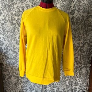 Yellow long sleeve with rainbow colors in the back